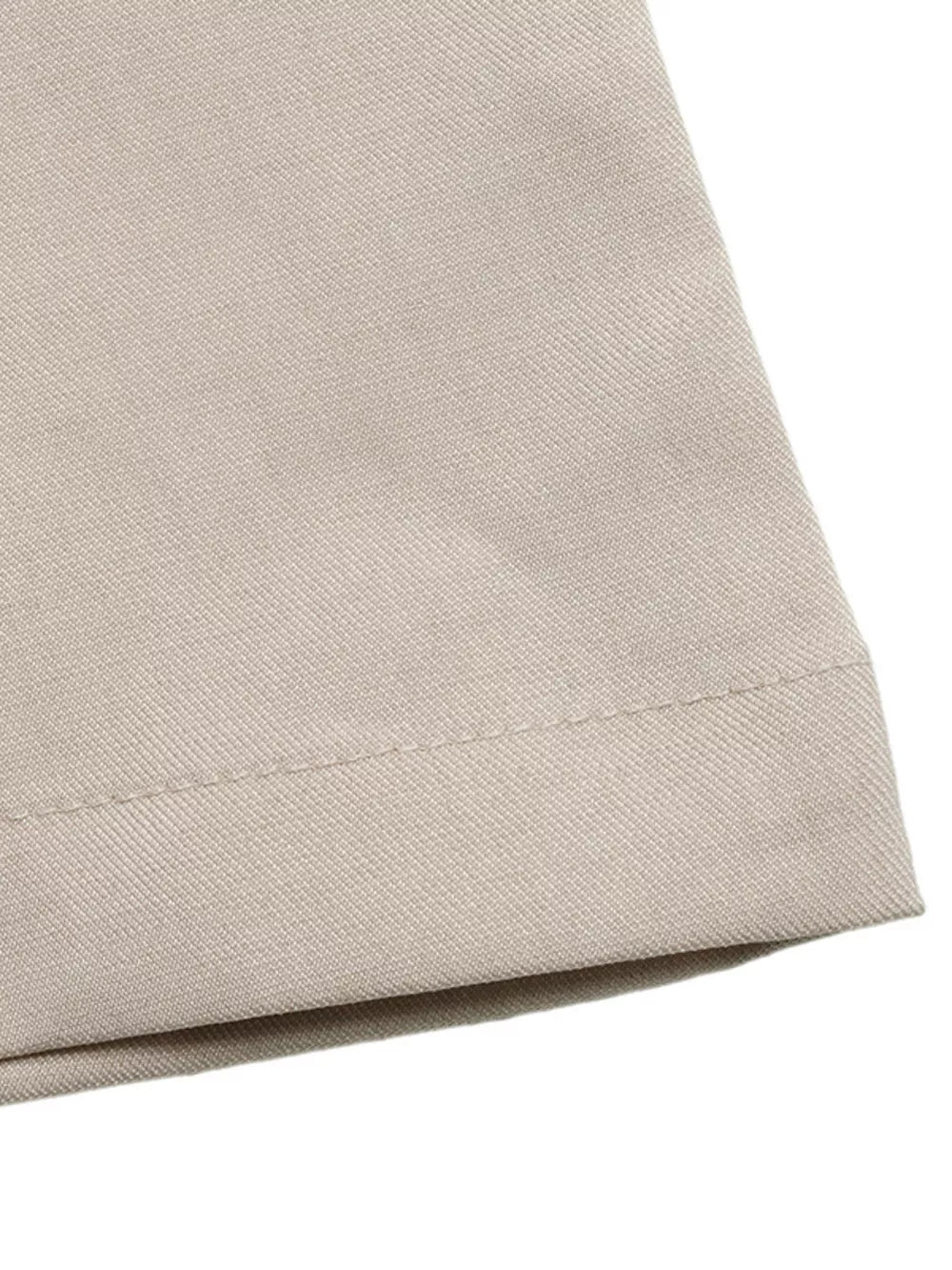 Elegant wide-leg romper in beige fabric with visible stitching detail.