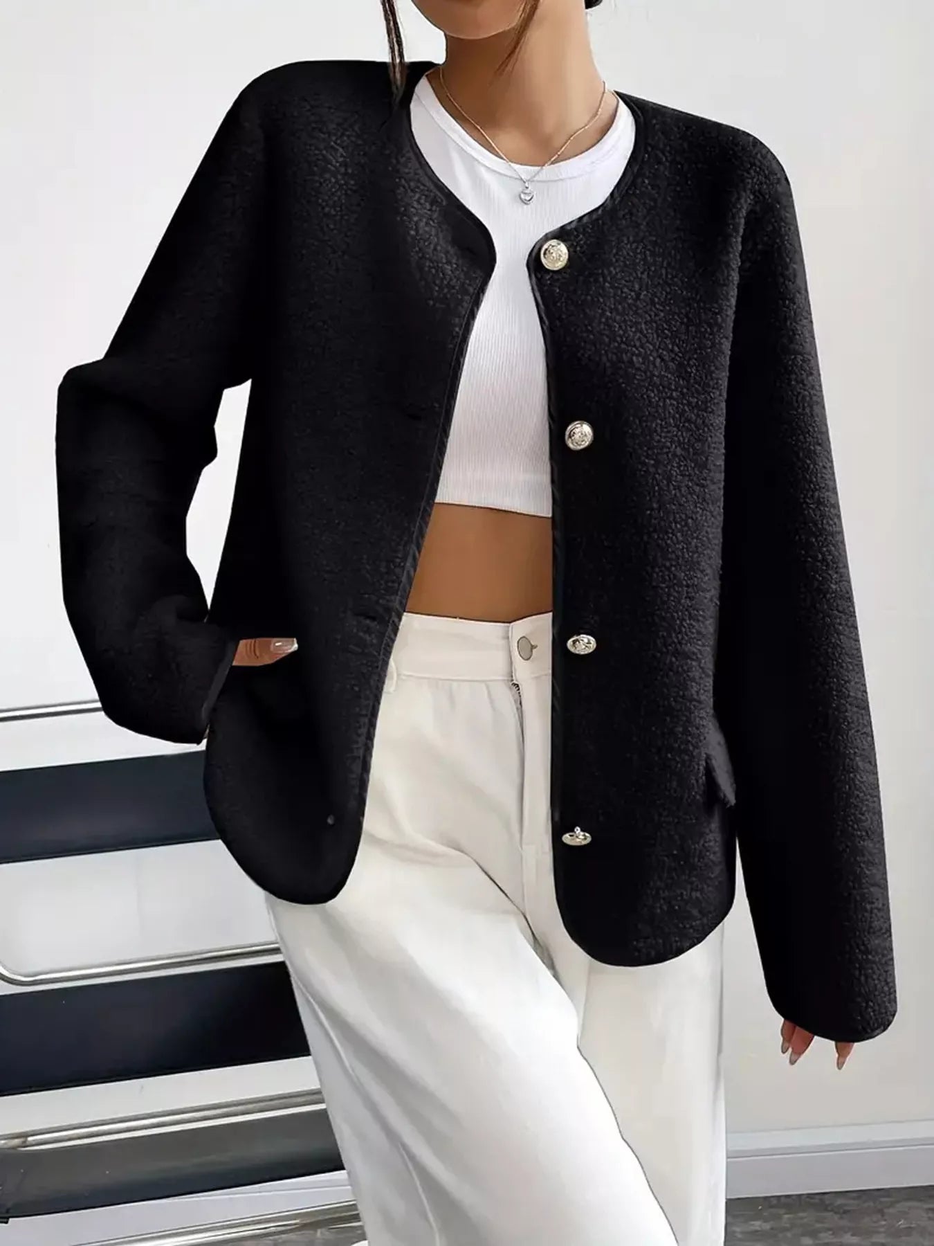 Black textured button-up fleece jacket with round neckline and silver buttons.