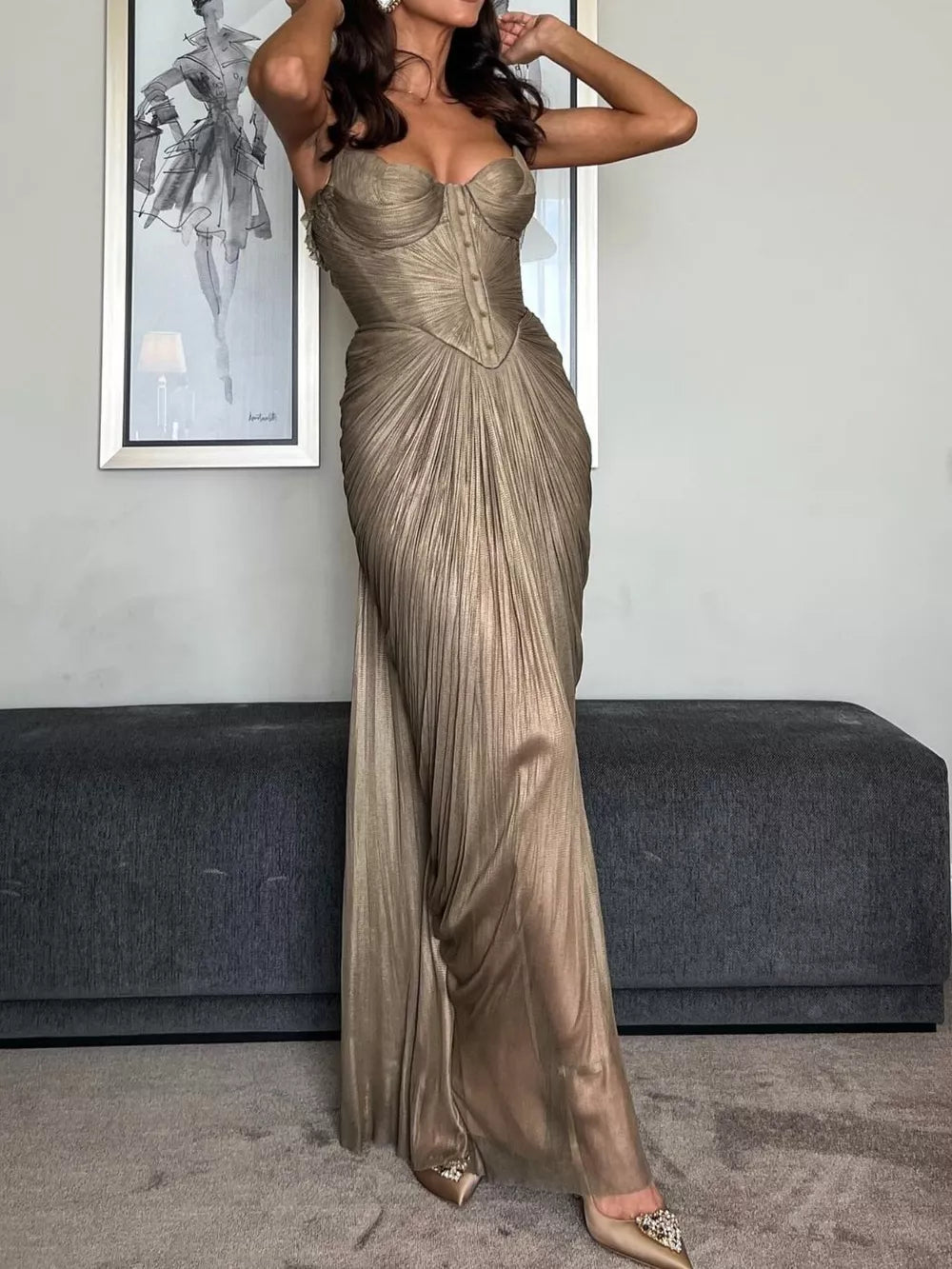 Gold metallic corset maxi gown with draped pleated skirt and lace-up back.