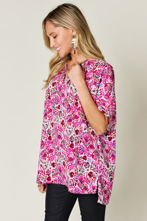 Floral ikat relaxed v-neck top in pink with short sleeves and side slits.