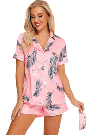 Pink botanical print satin pajama set with button front and shorts.