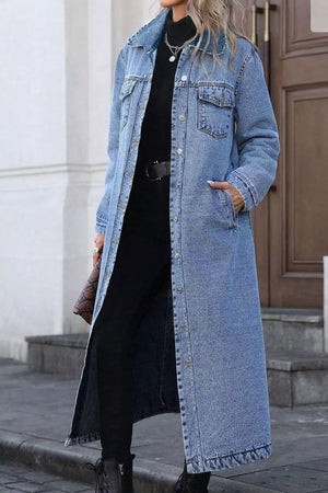 Longline blue denim jacket with pockets, button front, and collared neckline.