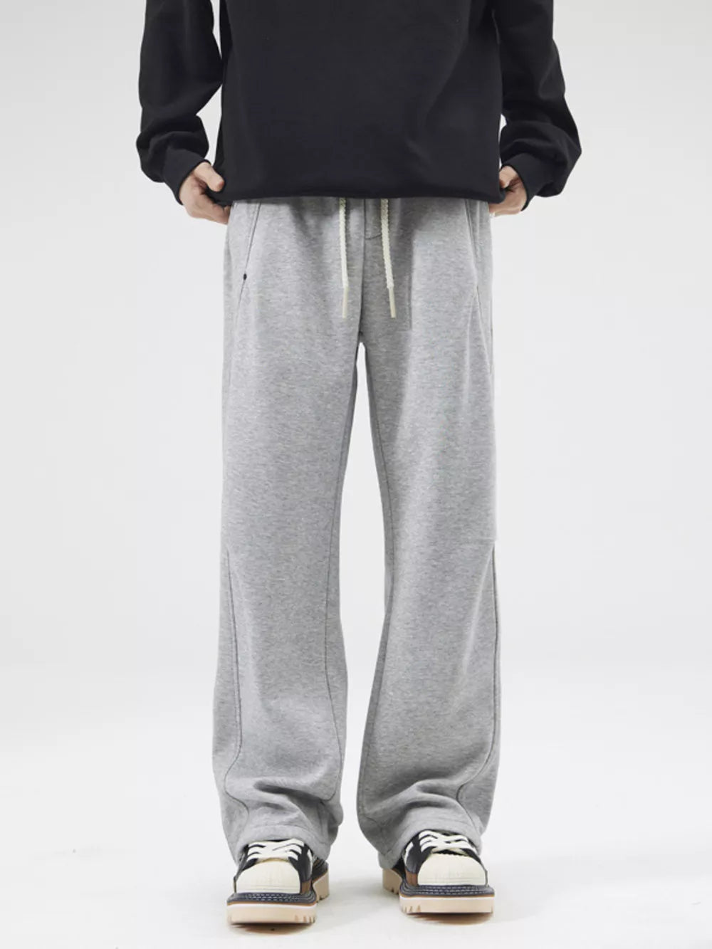 Grey casual loose-fit men's sweatpants with drawstring and pockets.