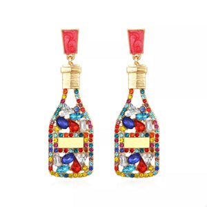 Color mixing champagne bottle drop earrings with colorful rhinestones and red tops.