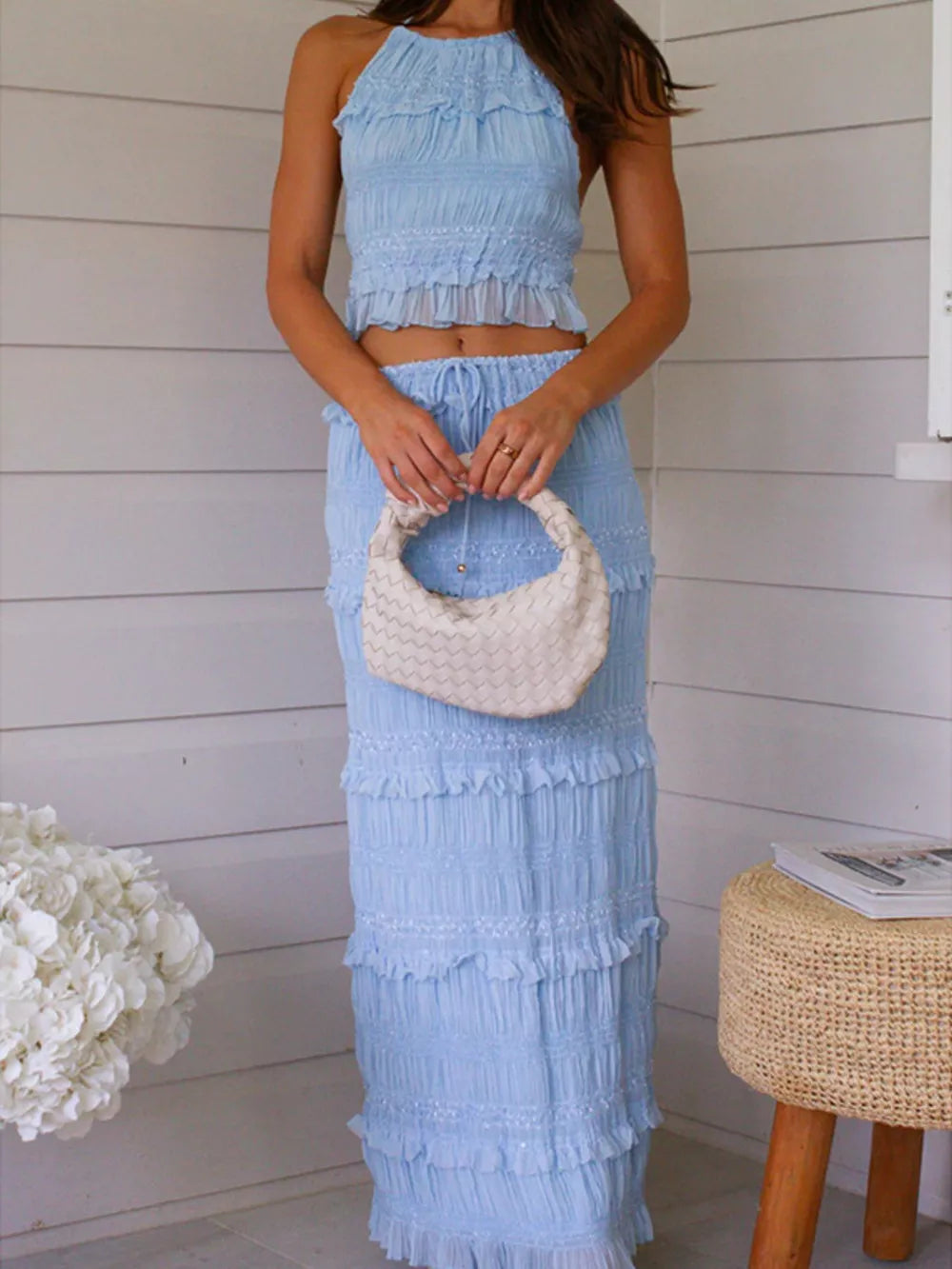 Light blue halter neck smocked crop top and tiered ruffle maxi skirt ensemble