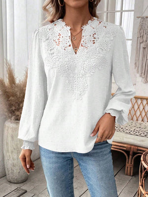 White embroidered yoke blouse with puff sleeves and textured fabric