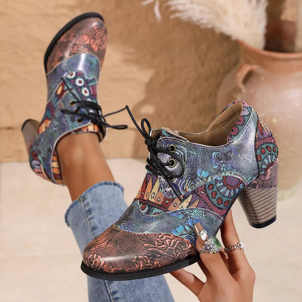 Floral patchwork lace-up ankle boots with a block heel and mixed patterns.