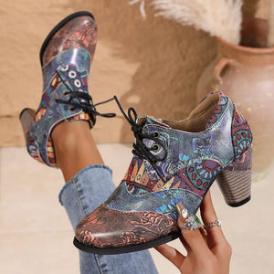 Floral patchwork lace-up ankle boots with a block heel and mixed patterns.