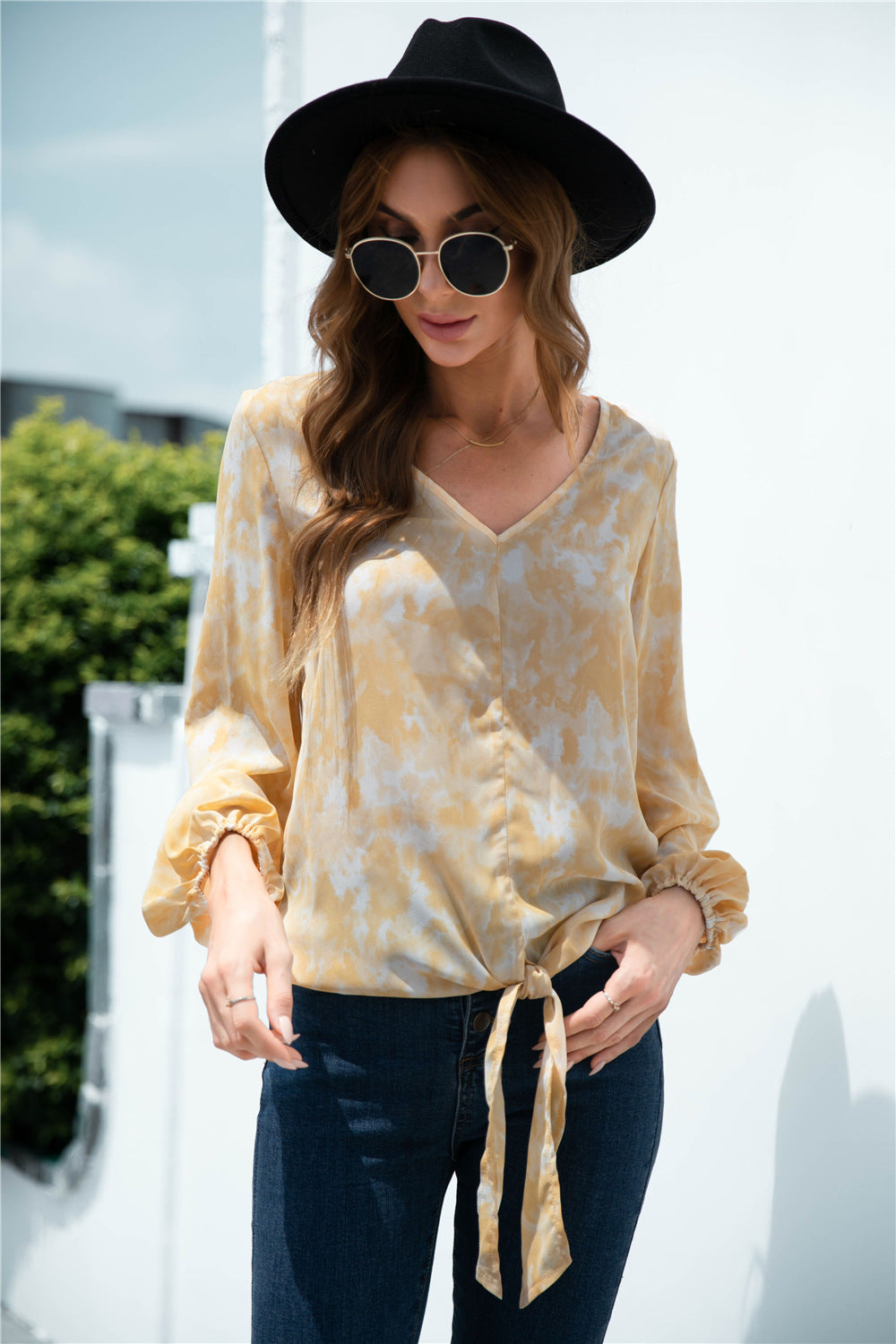 Light yellow swirl print blouson top with tie-front and balloon sleeves.