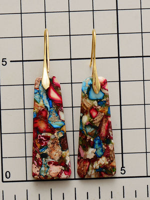Geometric stone drop earrings with multicolor stone and gold hooks.