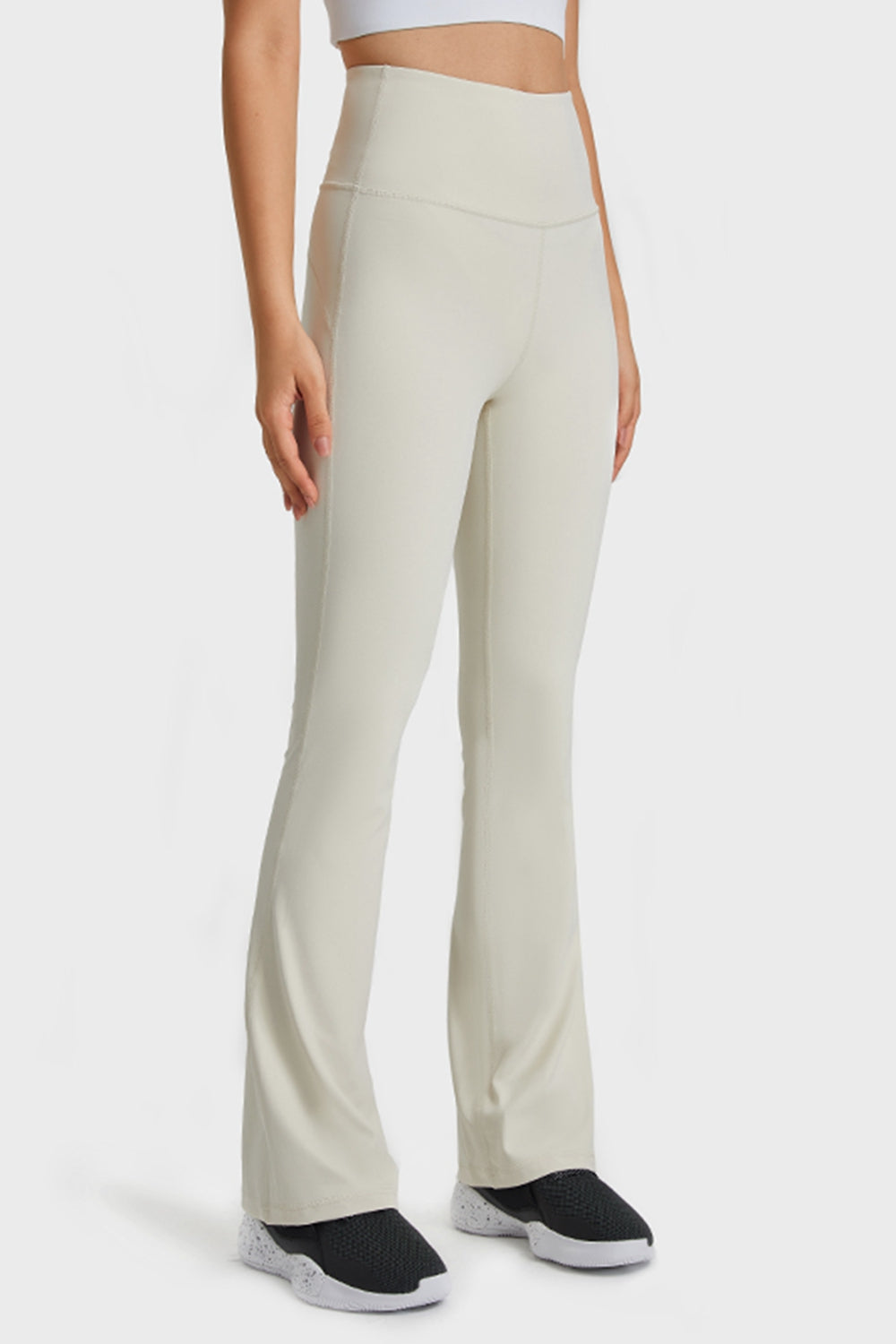 White flare yoga pants with a high waist and breathable fabric.