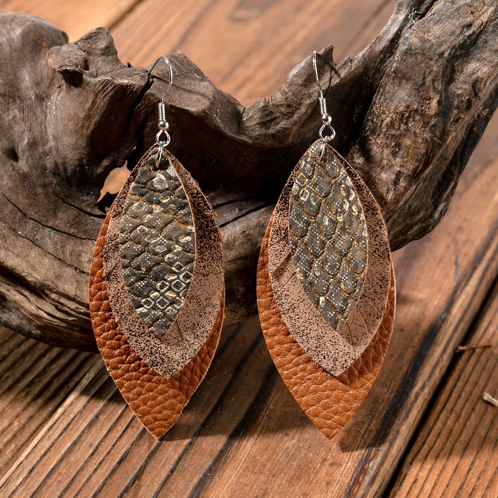 Layered faux leather statement earrings in brown with embossed pattern detail.