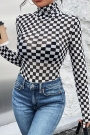Checkerboard mesh turtleneck bodysuit with long sleeves, styled with jeans.