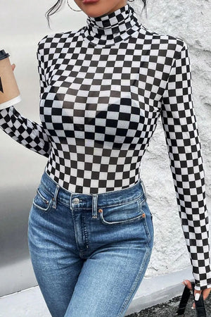 Checkerboard mesh turtleneck bodysuit with long sleeves, styled with jeans.