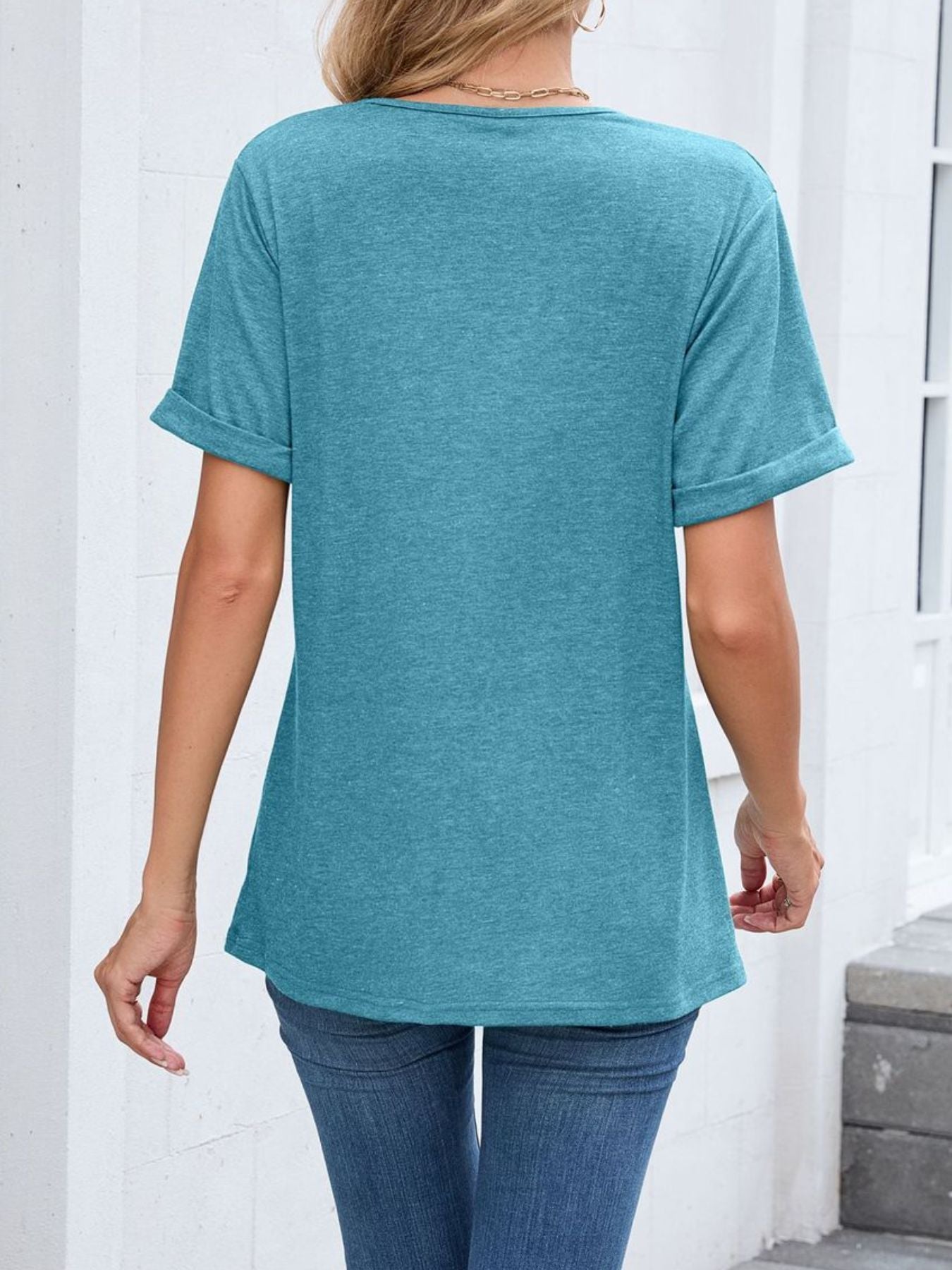 Blue-green V-neck t-shirt with cuffed short sleeves and a relaxed fit.