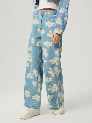 Light wash denim wide leg jeans with a white daisy print and button fly.