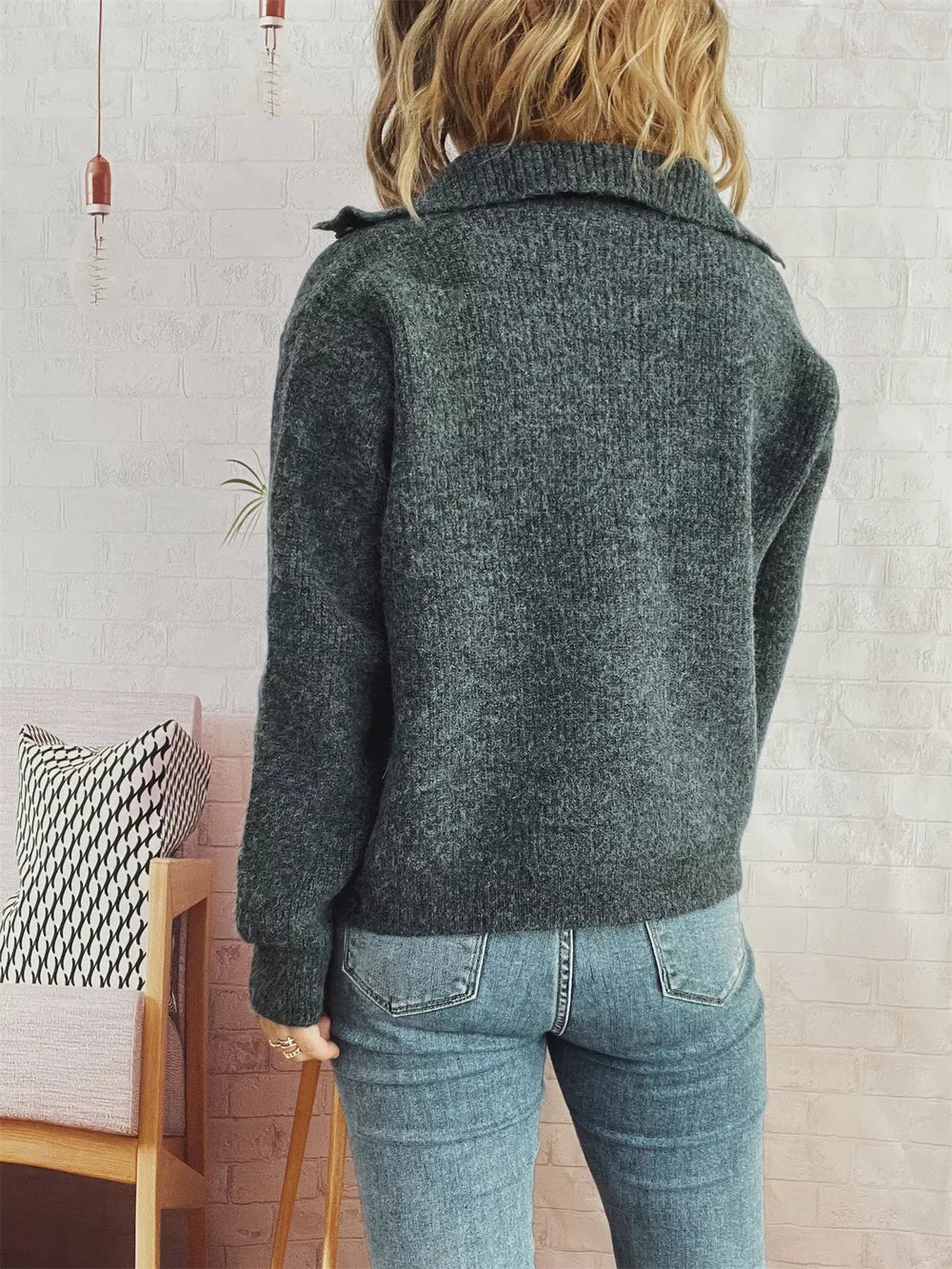 Gray ribbed cardigan with polo collar and button-up detail, worn with jeans.