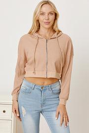 Waffle knit cropped zip hoodie in khaki with drawstring hood and long sleeves.