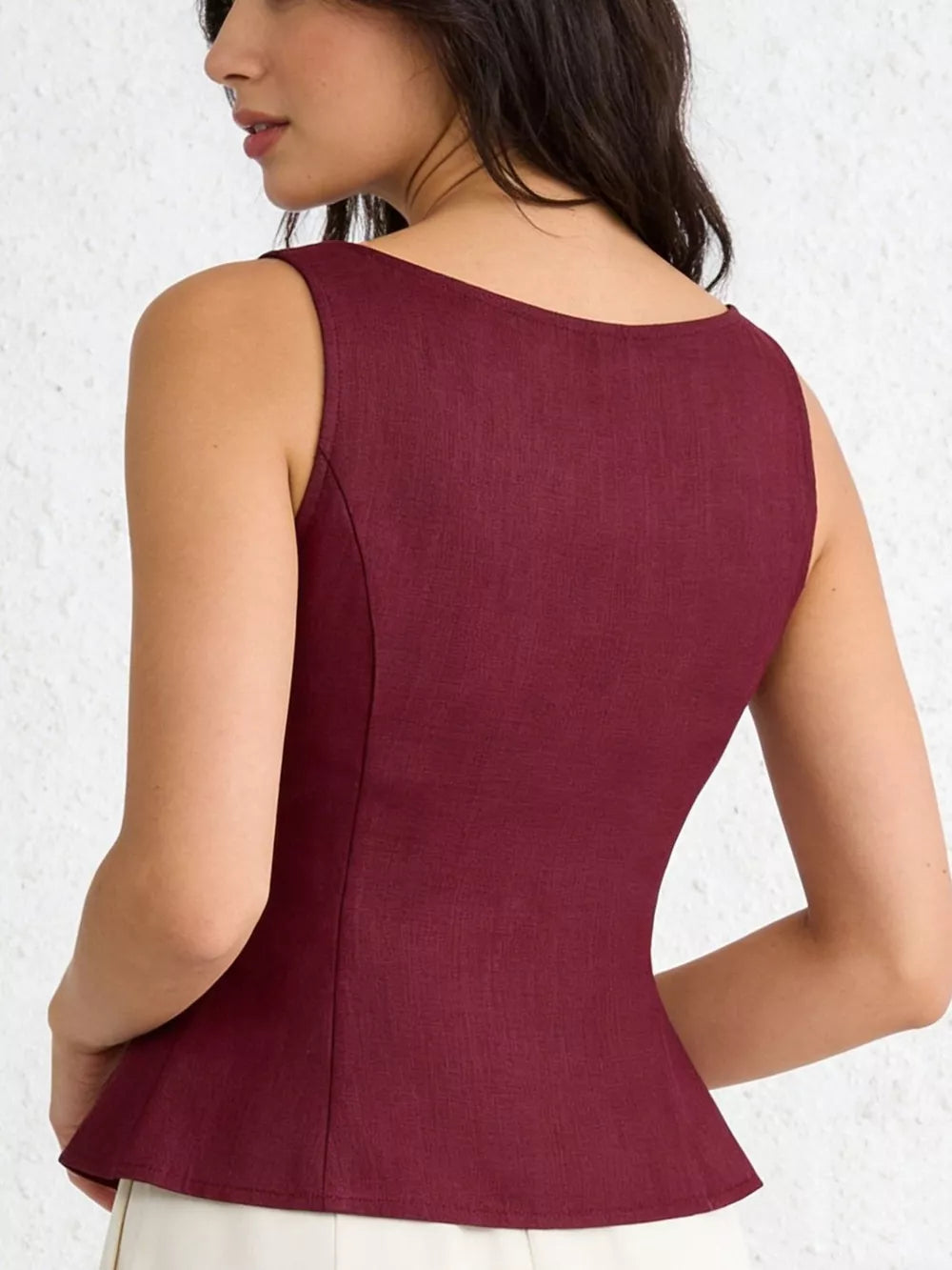 Burgundy tie-shoulder vest with button front and peplum hem.