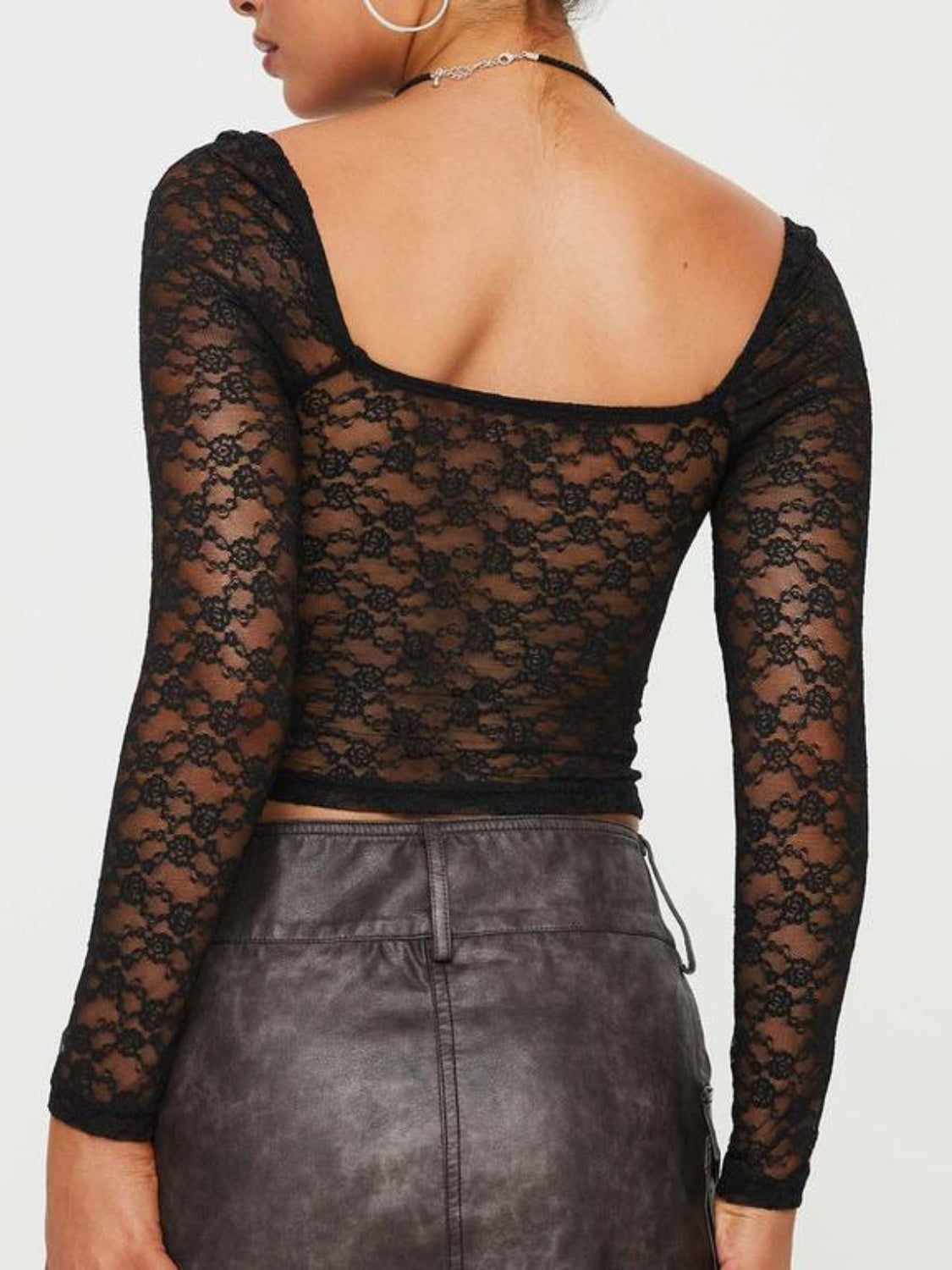 Black lace bustier top with sweetheart neckline and long sleeves.