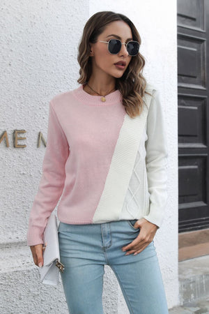 Diagonal knit sweater in blush pink and white with cable knit detail.