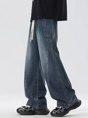 Oversized wide-leg jeans in blue denim with a drawstring waist and vintage wash.