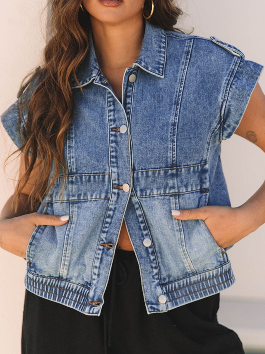 Boxy medium wash denim vest with button front, collar, and shoulder detail.