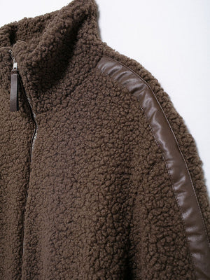 Brown teddy fleece zip-up jacket with contrast faux leather piping detail and stand-up collar.