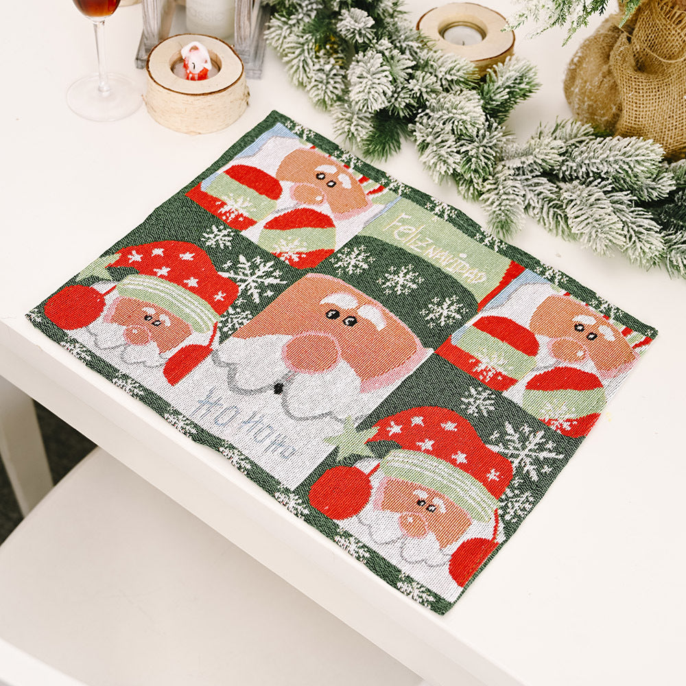 Embroidered Christmas placemat with Santa faces and Feliz Navidad text, green background