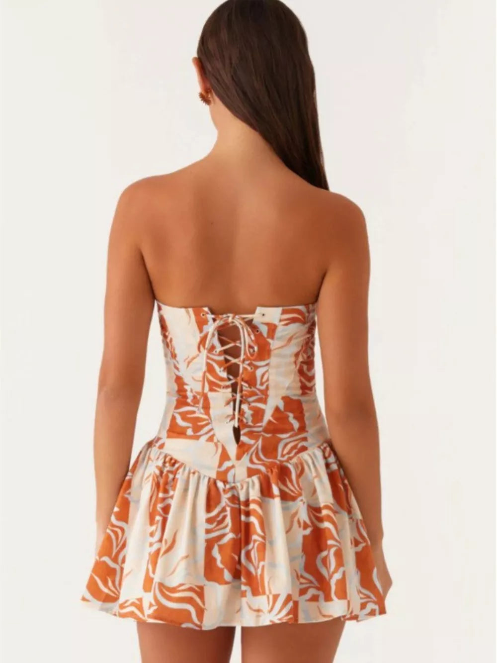 Ruffled tube dress with floral print and back tie detail.
