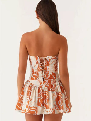 Ruffled tube dress with floral print and back tie detail.
