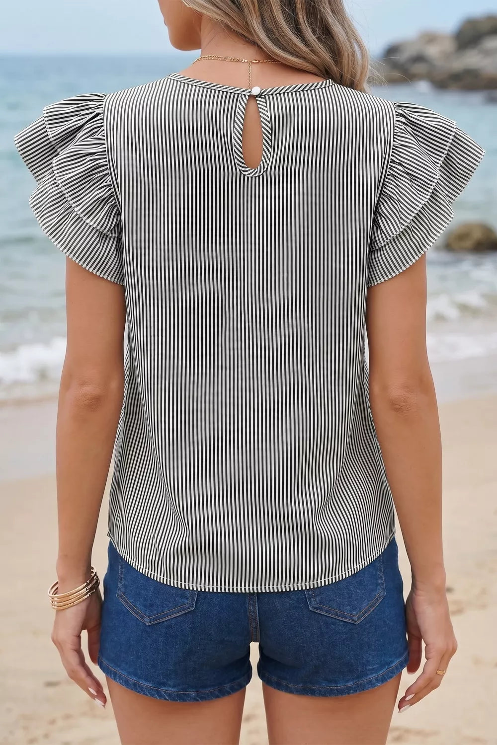 Chic striped polyester shirt with ruffle sleeves and keyhole back detail.