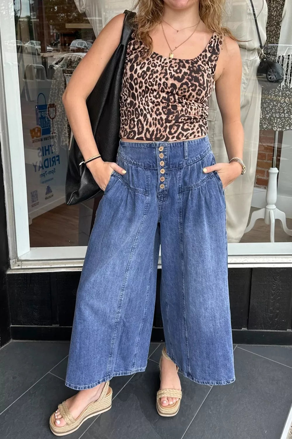 Elevated high-waisted wide-leg jeans in blue denim with button fly and ankle length.