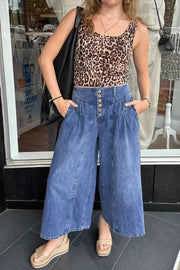 Elevated high-waisted wide-leg jeans in blue denim with button fly and ankle length.