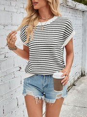Textured stripe knit top with cap sleeves in black and white, styled casually with denim shorts.