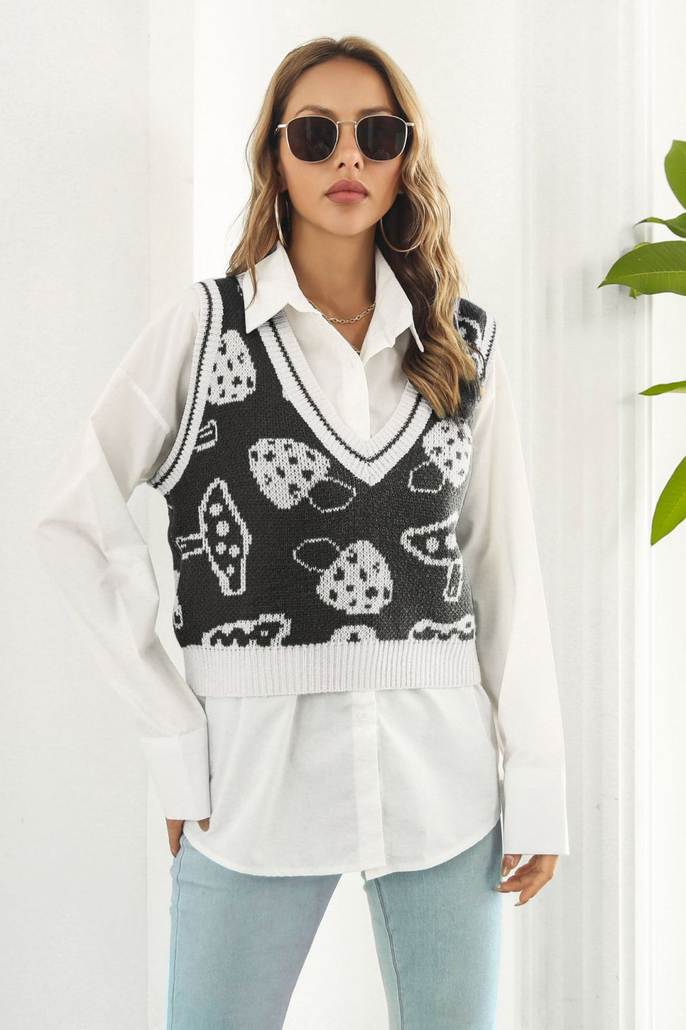 Black knit vest with white mushroom motif, V-neck, ribbed trim, acrylic.