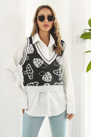 Black knit vest with white mushroom motif, V-neck, ribbed trim, acrylic.