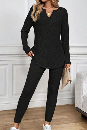 Black ribbed long sleeve set with notched V-neck top and fitted pants.