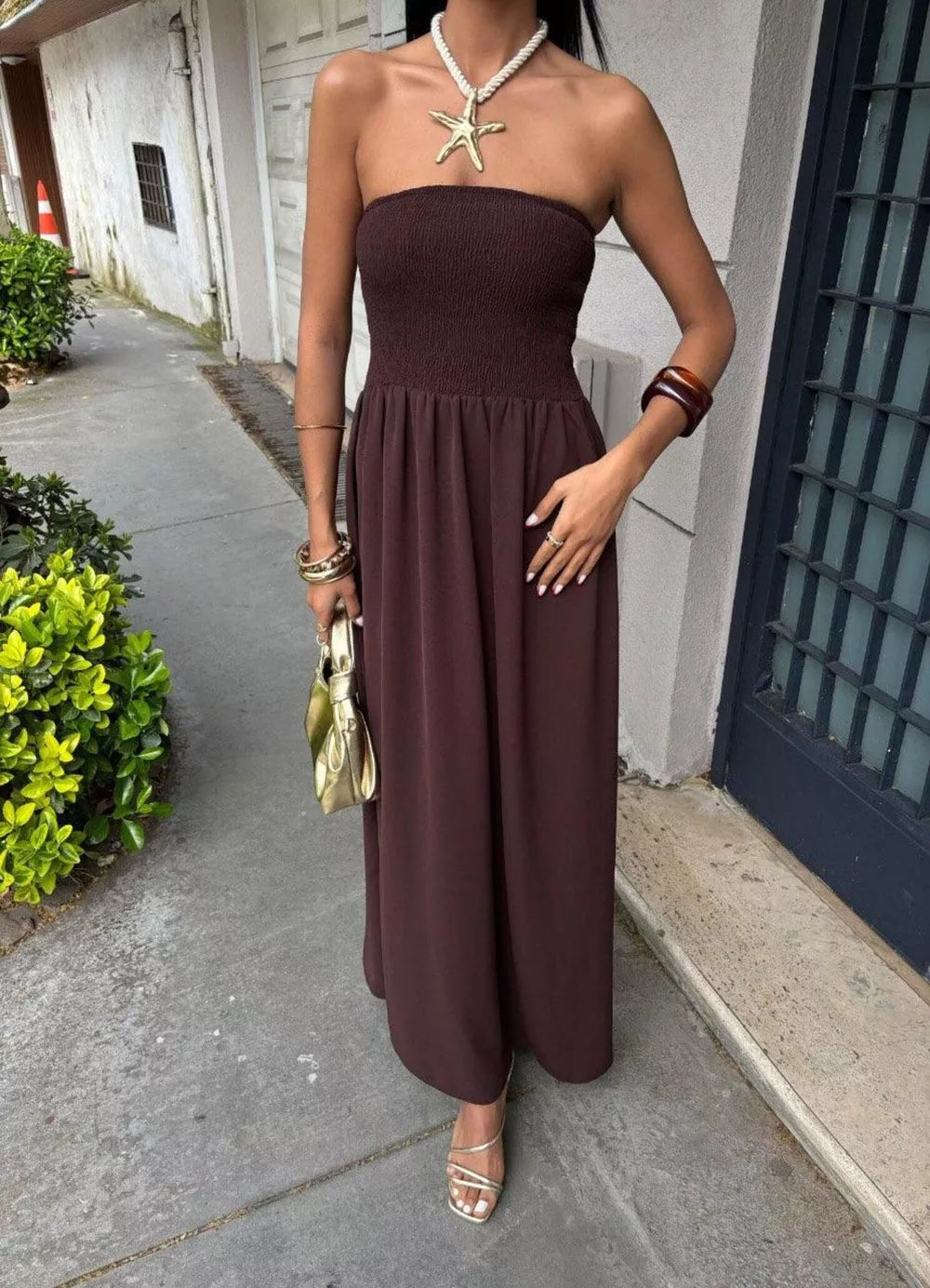 Dark brown smocked bodice relaxed maxi dress with a strapless neckline.