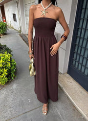 Dark brown smocked bodice relaxed maxi dress with a strapless neckline.