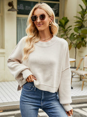 Dropped shoulder knit sweater in cream with balloon sleeves and a relaxed fit.