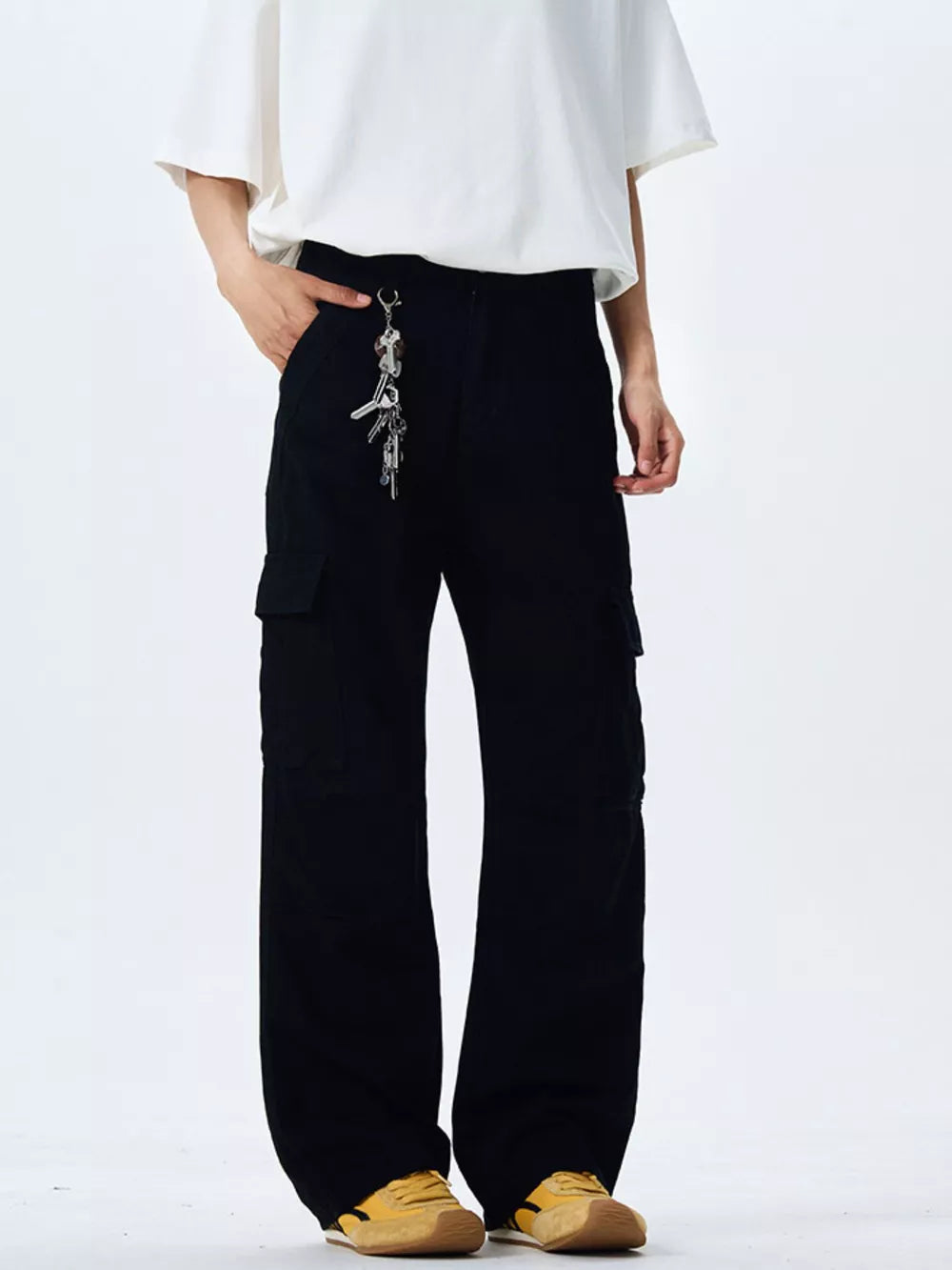 Black 100% cotton wide-leg cargo pants with a keychain detail and belt loops.