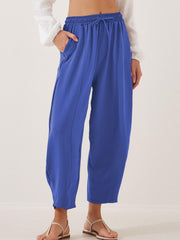Royal blue balloon-leg drawstring trousers with seam detail and pockets.