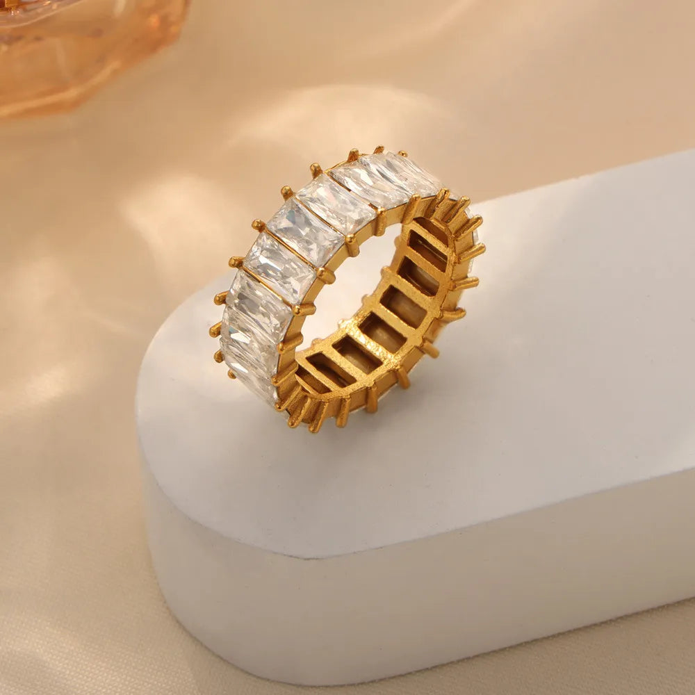 Gold baguette eternity band ring with clear rectangular stones