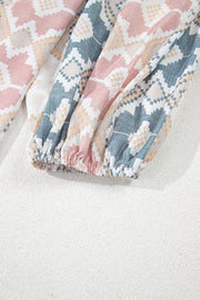 Geometric print blouse with elastic cuffs in floral colors.