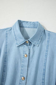 Light blue denim midi dress with collar, button front, and gold buttons.