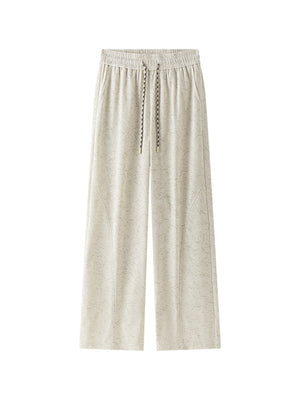 Men's beige corduroy drawstring pants with a subtle textured pattern.