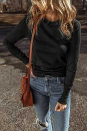 Black long sleeve crewneck knit top with ribbed cuffs and hem