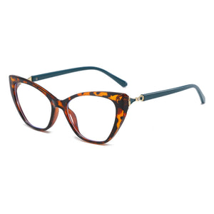 Vintage cat eye glasses with tortoise shell frames, clear lenses, and dark green arms.