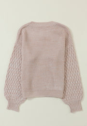 Tan textured knit sweater with diamond pattern sleeves and crew neck.